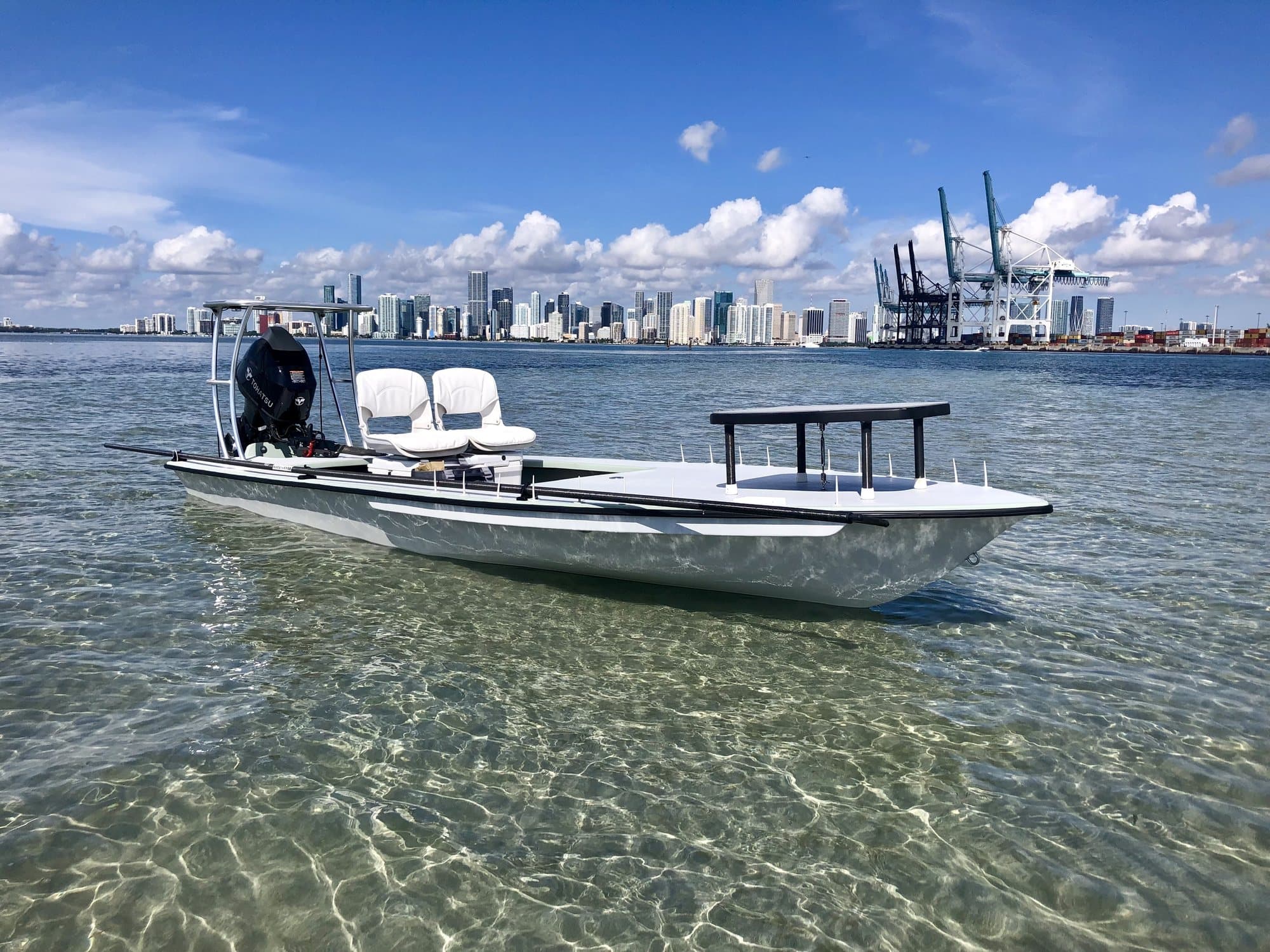 A Spear skiff floating on clear shallow water